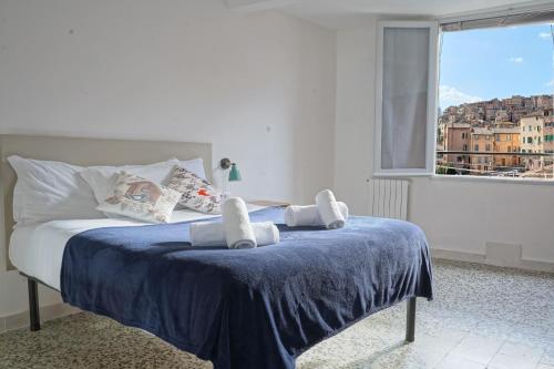 a bedroom with a bed with towels on it at Gest Short Rent Siena 4 in Siena