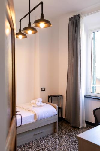 a small bedroom with a bed and a window at Trilocale Luxury - 5 minuti Acquario di Genova in Genoa