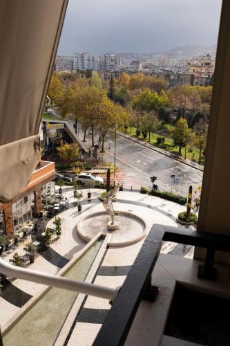 a view from a window of a city with a fountain at Terra Boutique Hotel in Tirana