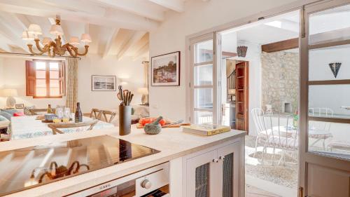 a kitchen and living room with a large window at Lleo Eleven in Pollença