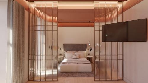a bedroom with a bed and a flat screen tv at Fahana Triana 54 Adults Only in Las Palmas de Gran Canaria