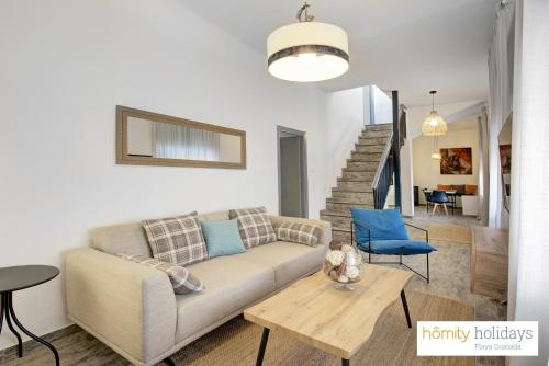a living room with a couch and a table at Homity Holidays - Gualchos - Casa Río Oculto in Gualchos