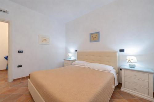 a small bedroom with a bed and a dresser at Hotiday Rooms Porto Rotondo in Porto Rotondo