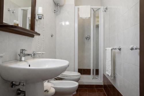 a bathroom with a sink and a toilet and a shower at VillaGrancassa Hotel Relais in San Donato Val di Comino