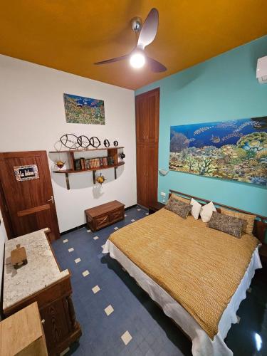 a bedroom with a bed and a painting on the wall at Villa La Drianké in Dakar