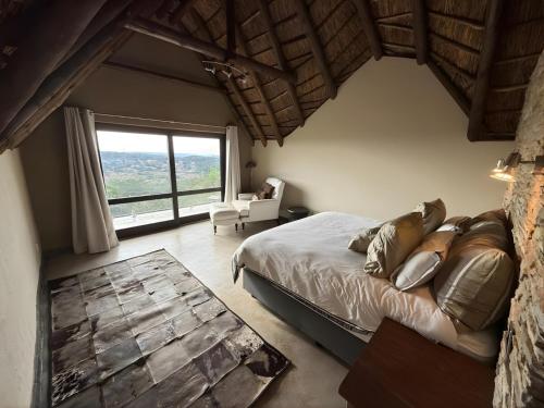 a bedroom with a bed and a large window at Castle View in Pretoria