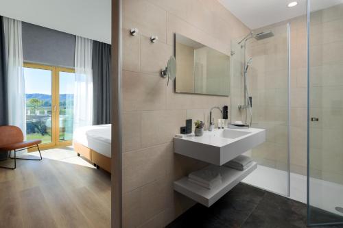 a bathroom with a sink and a shower at mk hotel tirana in Tirana