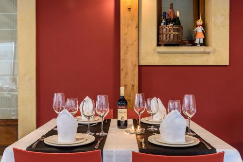 a table with wine glasses and napkins on it at Hotel Palacio Muñatones in Muskiz