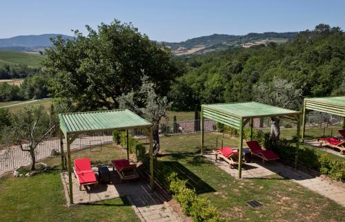 a group of chairs and umbrellas in a yard at Spa Resort Fonte Alla Lepre in Riparbella