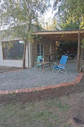 a patio with two chairs and a table in front of a house at Finca Santiago in San Miguel del Monte