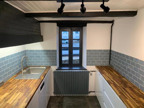 a kitchen with a sink and a window at Vacances au Lac de Saint-Pardoux in Compreignac