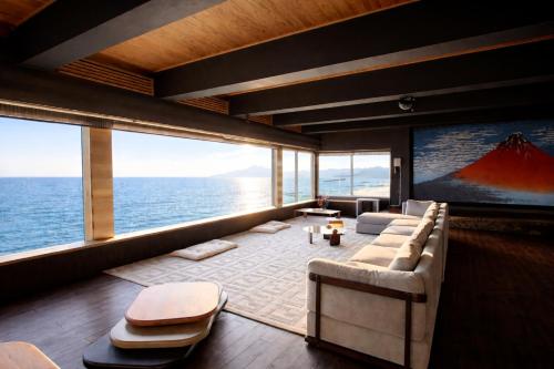 a living room with a view of the ocean at Moonbay Beach Villa in Lake Toya