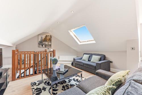 a living room with a couch and a table at Harrogate Lifestyle Apartments Ltd in Harrogate