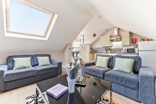 a living room with two couches and a table at Harrogate Lifestyle Apartments Ltd in Harrogate