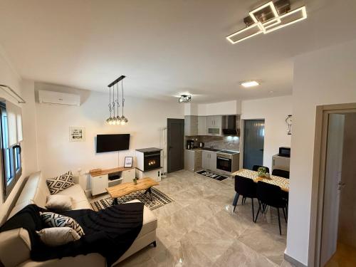 a large living room with a couch and a table at Eunoia Homestay & BnB - Loutra Pozar, Aridaia in Aridaia