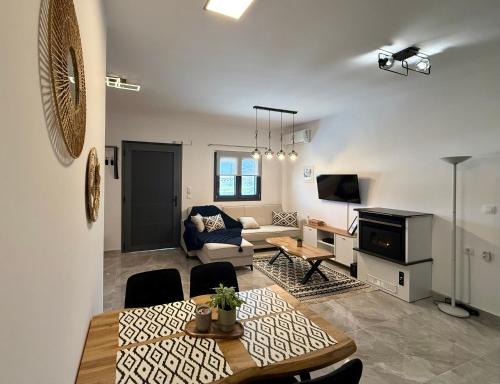 a living room with a couch and a table at Eunoia Homestay & BnB - Loutra Pozar, Aridaia in Aridaia