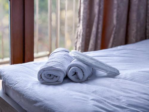 a towel and a knife sitting on top of a bed at Three Lion Hotel in Batumi