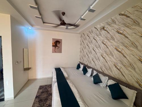 a bedroom with a bed with a stone wall at Hotel Hanuman Palace-450 meter Khatu Shayam Ji Temple in Khātu
