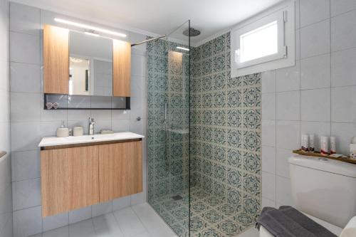 a bathroom with a shower and a sink at Clara Terra in Mytakas