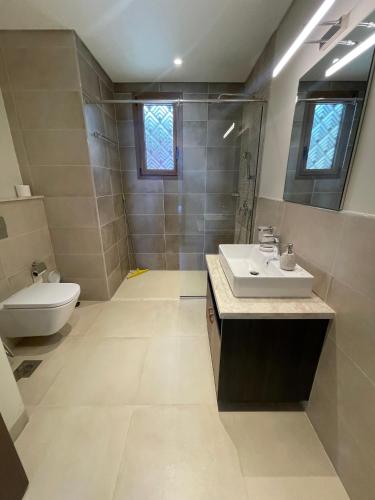 a bathroom with a sink and a toilet at Hakuna Matata Villa - BF 515A in Muscat