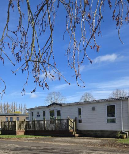a large white building with a fence at Parkview Billing Aquadrome in Great Billing