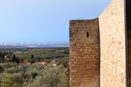 a brick wall with a view of a city at Locanda Delle Mura Anna De Croy in Magliano in Toscana
