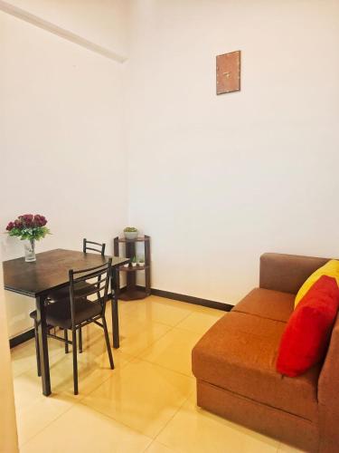 a living room with a couch and a table at Banana Leaf Villa in Nikawatawana