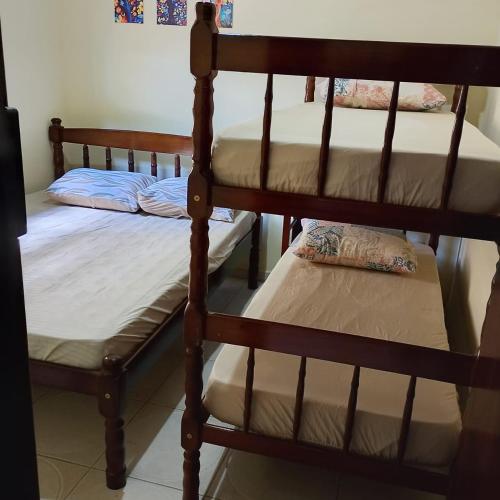 a couple of bunk beds in a room at Pousada Menino do Rio in Ubatuba
