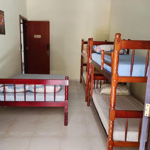 a room with two bunk beds in a room at Pousada Menino do Rio in Ubatuba