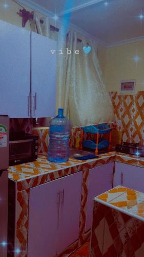 a kitchen with a bottle of water sitting on a counter at Kash apartments in Diani Beach