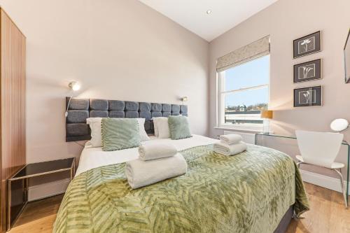 a bedroom with a large bed and a window at Harrogate Lifestyle Apartments Ltd in Harrogate
