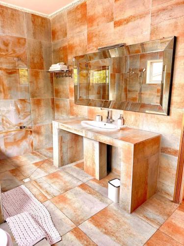 a bathroom with a sink and a mirror at BEST HOTEL Aero-Batignoll in Brazzaville