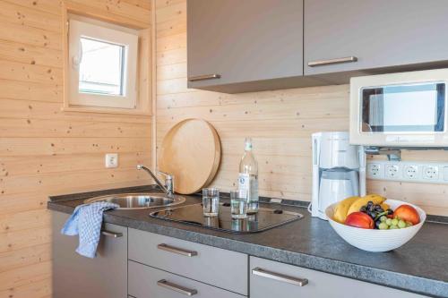 a kitchen with a bowl of fruit on a counter at Hausboot Sunshine Heiligenhafen in Viehhof