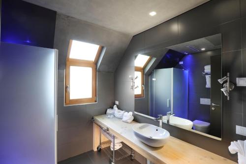 a bathroom with a sink and a mirror at Lago & Monte Varese Apartments near Hospital and University in Varese