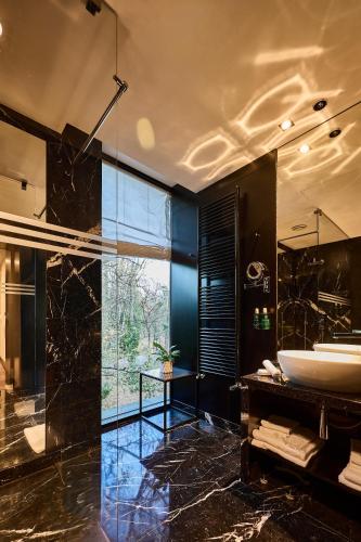 a bathroom with a tub and a sink at Platinum Palace Boutique Hotel & SPA in Wrocław