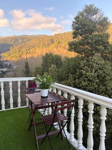 a table and chairs on a balcony with a view at Mirante Canto Das Águas Hidden Nature Escape near Geres in Lordelo