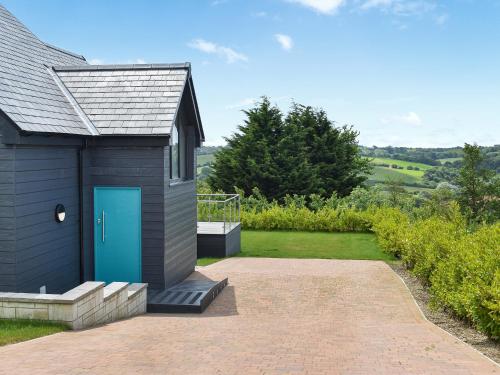 a small house with a blue door on a patio at Shannon - Uk46405 in Newport