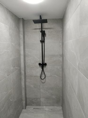 a bathroom with a shower with a lamp on the wall at Apartamento Catalina in Algodonales
