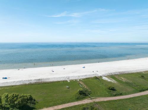 an aerial view of a large white beach at MarinaPark Beach Resort Soal | Beachfront villas in Workum