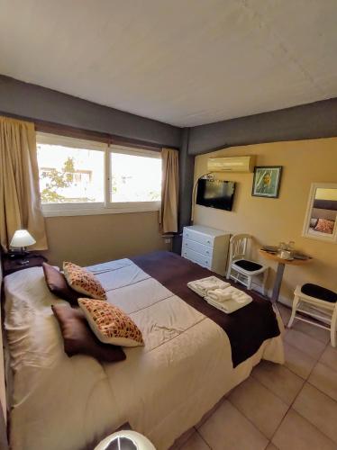 a bedroom with a large bed with pillows on it at Plaza Milenium in San Rafael