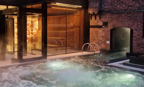 a hot tub in a room with a brick wall at Hope Street Hotel in Liverpool