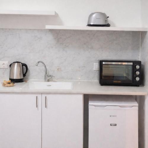 a microwave oven sitting on top of a kitchen counter at R suite delux in Netanya