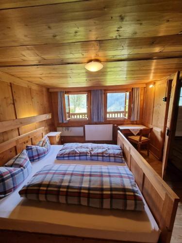 a bedroom with two beds in a cabin at Ferienhaus im Bergidyll in Sankt Jakob in Defereggen