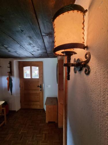 a light on the wall of a room with a door at Ferienhaus im Bergidyll in Sankt Jakob in Defereggen