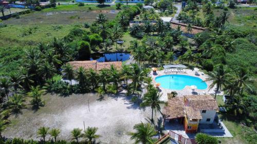 an aerial view of a resort with a swimming pool at Costamar Pousada e Restaurante in Una