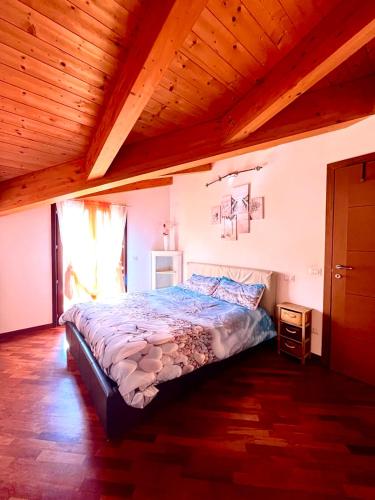 a bed in a bedroom with a wooden ceiling at Raggio di Sole in Montesilvano