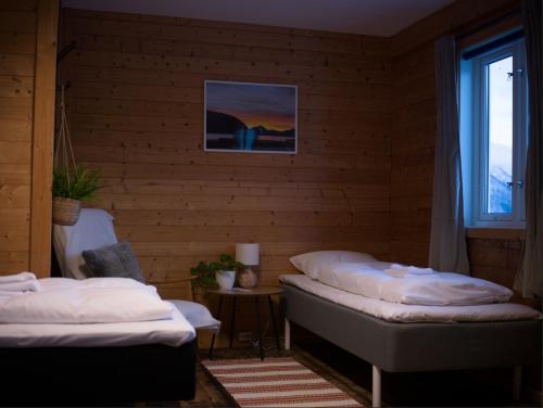 a room with two beds and a window at Arctic Ocean Lodge in Skjolde