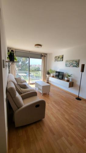 a living room with a couch and a table at Apartamento VALLFOGONA Relax in Santa Bárbara
