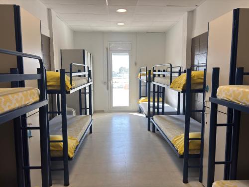 a hallway with bunk beds in a dorm room at Alberg Deltebre Xanascat in Deltebre