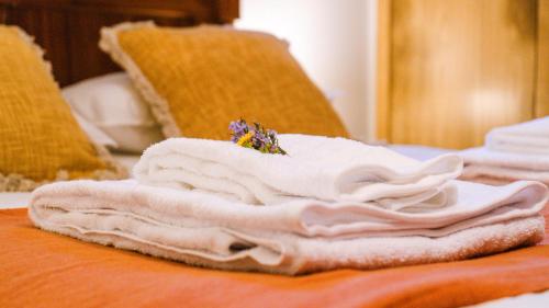 a pile of white towels sitting on a table at Casa do Outeiro in Vila Meã